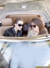 Cool lesbians ride a car and end up fucking each other on a bed