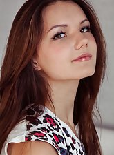 Shorts-wearing teenage cutie playing around while undressing