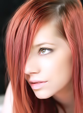 Beautiful redhead angel Gabrielle Lupin strips on the bed and shows her hooters.