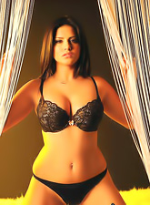 Hot busty brunette Sunny Leone strips her black lingerie and shows her big jugs.