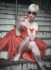 Hot blonde lady Lynn Pops strips her red dress and shows us her beautiful jugs.