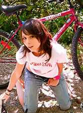 Ariel Rebel rides a bicycle to get into the forest and to get rid of her clothes.