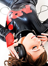 Divine babe, Ariel Rebel, tries on a black latex outfit and high-heeled shoes.