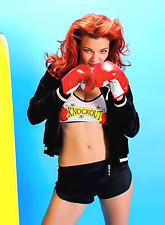 Tempting redhead Danielle Riley in black hot pants revealing the power of her tits.