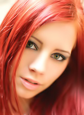 Beautiful redhead model Gabrielle Lupin stirps outdoors and shows her melons.