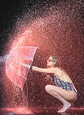 Heather Elizabeth posing with an umbrella while wearing a cute and sexy swimsuit.