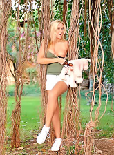 Cute blond babe Alison Angel shows her beautiful boobs while posing in the woods.