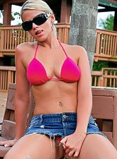 Ann Angel strips her hot pink lingerie before the camera and shows her big jugs.