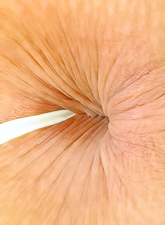 Liz Honey strips her denim skirt off on the bed and teases us with her amazing ass.