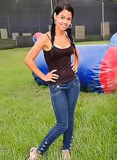 Attractive tanned brunette with hot body Gigi Spice posing in tight jeans and t-shirt.