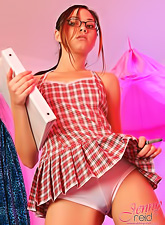 Nerdy teen girl Jenny Reid slowly strips on her bed and shows us her round ass.