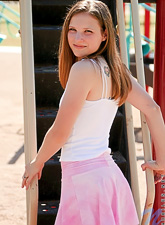 Absolutely gorgeous cutie is ready for some posing outside. Such a nice gal in a pink skirt