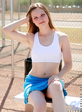 Impressive teenage model pulls up her top and displays her natural boobies on the playground