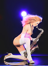 Seductive Sandra C plays saxophone and takes off her tiny outfit at the same time.