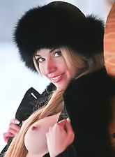 Natalia B takes her fur coat outdoors and teases us with her perky breasts.
