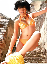 Horny short hairred teen True Tere takes off her yellow pants and shows her boobs.