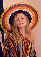 Hot teen gal Kristina Fey takes off her poncho and shows us her round breasts.