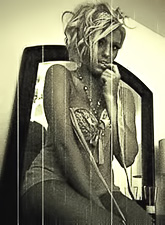 Alluring blonde babe Ember Reigns strips her clothes and shows her tight round ass.