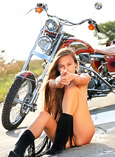 Freya A takes her slutty outfit in front of the motor bike and shows her hot ass.