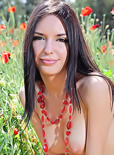 Sexy Nika E walks in the poppy meadow and plays with flowers and her naked self.