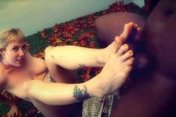 Impressive mature honey gives a fine footjob and slurps on a huge chocolate dick so damn fine