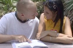 Tanner Mayes kneels before her hung lover and slurps on her lover's hard cock