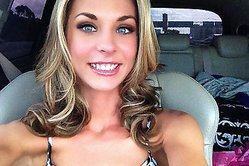 Fetching blonde babe moves her pink panties aside and fingers her pussy in a car