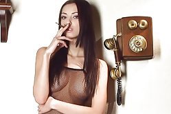 Here's another fantastic babe with a smoking fetish, she bares her tight twat and those juicy boobs